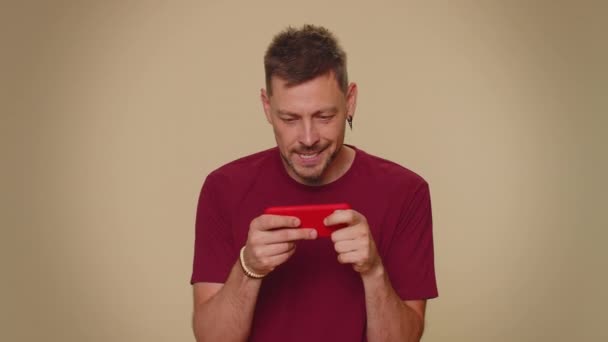 Worried Funny Young Man Red Shirt Enthusiastically Playing Racing Shooter — Vídeo de Stock