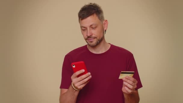 Happy Young Man Use Smartphone Plastic Credit Bank Card Browsing — Vídeo de Stock