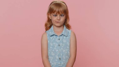 Funny amusing preteen child girl kid making playful silly facial expressions and grimacing, fooling around, looking awkward with crossed eyes. Little toddler children stupid brainless dumb expression