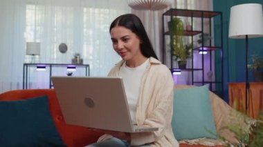 Oh my God Wow. Young woman use laptop computer, receive good news message, shocked by sudden victory, celebrate win, purchases online shopping at home. Modern technologies. Amazed caucasian girl