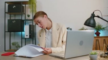 Stressed businesswoman in formal suit feeling worried about financial problem doing paperwork at office. Concentrated female freelancer woman frustrated thinking of money debt, budget loss, bankruptcy