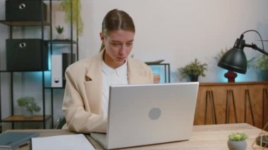 Businesswoman working on laptop computer shakes finger and saying no, be careful, scolding and giving advice to avoid danger mistake, disapproval sign at office. Confident serious freelancer girl