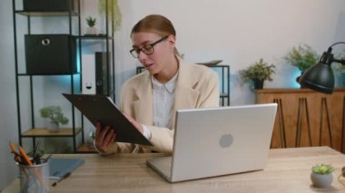 Video screen view of businesswoman work on laptop computer at office talk on online communication interview video call with employee, boss. Manager woman freelancer support services looking at camera