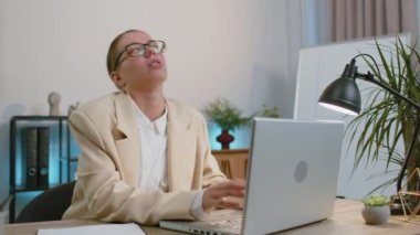 Problem, break up, depressed feeling, crisis, burnout, bankruptcy, deadline, budget loss, burnout. Businesswoman in suit working with laptop at office drinking champagne. Freelance woman. Girl worker