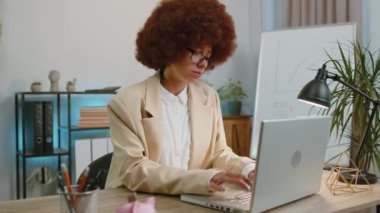 Dislike. Upset businesswoman working on laptop computer at home office thumbs down sign gesture, expressing discontent, disapproval, dissatisfied bad work. Displeased serious female freelancer woman