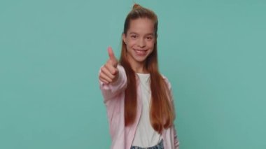 Like. Lovely pretty teenager girl raises thumbs up agrees with something or gives positive reply recommends advertisement likes good. Young stylish child kid isolated alone on blue studio background