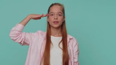 Yes sir. Subordinate, responsible serious teenager young girl giving salute listening to order as if soldier, following discipline, obeying, expressing confidence. Student child kid on blue background