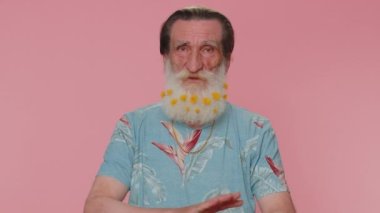 Displeased upset man reacting to unpleasant awful idea, dissatisfied with bad quality, wave hand, shake head No, dismiss idea, dont like proposal. Elderly grandfather on pink studio wall background