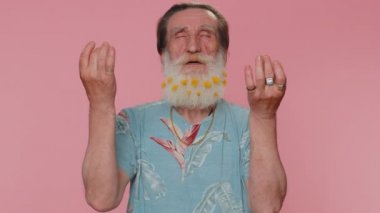 Keep calm down, relax, inner balance. Senior man hipster with flowers in beard breathes deeply with mudra gesture, eyes closed, meditating with concentrated thoughts peaceful mind. Elderly grandfather