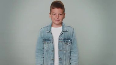 Oh my God, Wow. Excited amazed winner children boy raising hands in surprise looking at camera with big eyes, shocked by sudden victory. Sincere young teenager child isolated on gray studio background