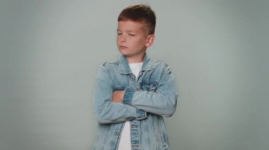 Displeased upset boy reacting to unpleasant awful idea, dissatisfied with bad quality, wave hand, shake head No, dismiss idea, dont like proposal. Young children teenager. Child on gray background