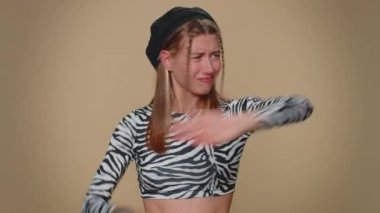 Get out of here. You are fired. Dissatisfied young woman pointing finger away asking to leave her alone, strict boss firing, conflict, crisis, deadline. Adult stylish girl on beige studio background