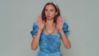 I will not say anyone. Frightened young woman closing her mouth with hand, looking intimidated scared at camera, gestures no, refusing to tell terrible secret, unbelievable truth. Adult female girl