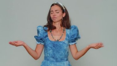 Displeased upset pretty young woman reacting to unpleasant awful idea, dissatisfied with bad quality, wave hand, shake head No, dismiss idea, dont like proposal. Adult stylish girl on gray background