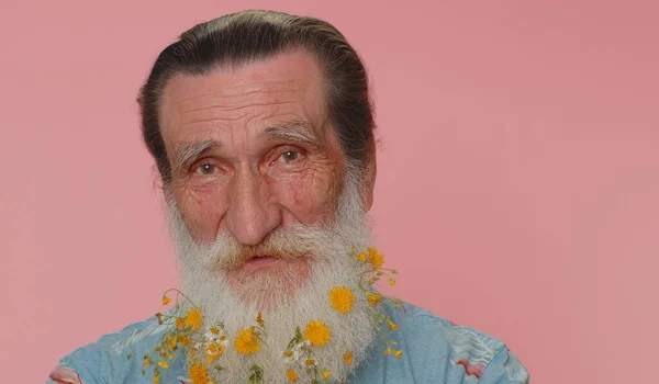 Cheerful Lovely Elderly Man Beard Flowers Blue Shirt Smiling Looking — Stok fotoğraf