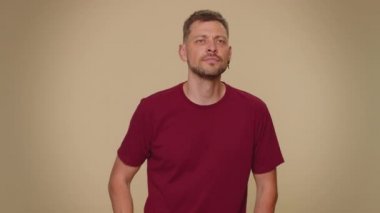 Oh my God, Wow. Excited amazed man looking surprised at camera with big eyes, shocked by sudden victory game winning, lottery goal achievemen, good news. Adult guy on beige studio background indoor
