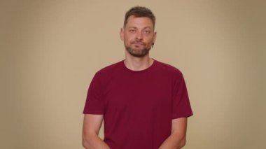 Displeased upset handsome young man reacting to unpleasant awful idea, dissatisfied with bad quality, wave hand, shake head No, dismiss idea, dont like proposal. Adult stylish guy on beige background