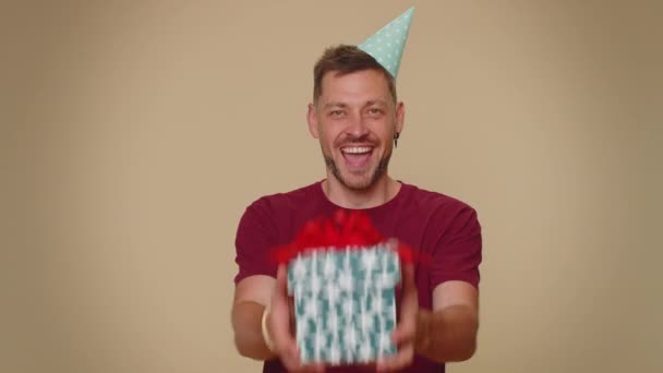 Positive Smiling Bearded Handsome Young Man Presenting Birthday Gift Box — Stockvideo