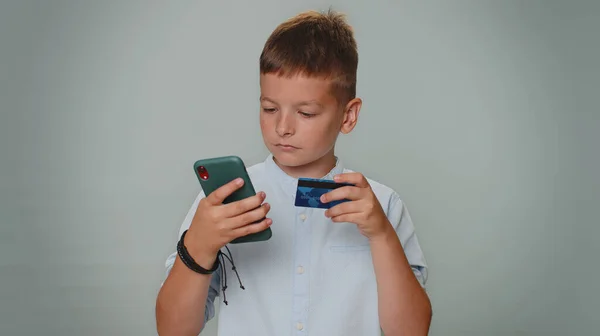 Sincere Toddler Boy Customer Using Credit Bank Card Smartphone While — Stockfoto