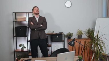 Businessman in suit thinking about an important creative project work decision at home office desk. Confident serious male manager freelancer man busy occupation looking through analytical reports