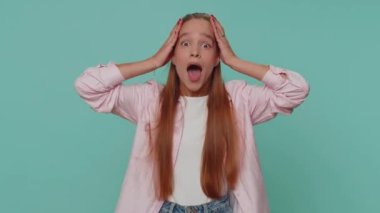 Oh my God, Wow. Excited amazed girl looking surprised at camera with big eyes, shocked by sudden victory game winning, lottery goal achievemen, good news. Child kid on blue studio background indoor