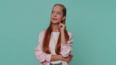 Eureka. Inspired girl pointing finger up with open mouth, having good idea, plan, startup, showing inspiration motivation gesture, problem solution. Young stylish child kid on blue studio background