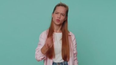 Quarrel. Displeased pretty teenager girl gesturing hands with irritation and displeasure, blaming scolding for failure, asking why this happened. Child kid isolated on blue studio background indoors