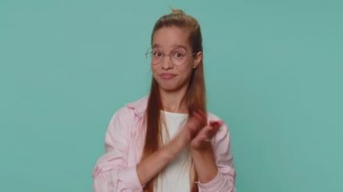Great nice job. Pretty teenager young girl showing thumbs up and nodding in approval, successful good amazing work, satisfaction results. Student child kid isolated on blue studio background indoors