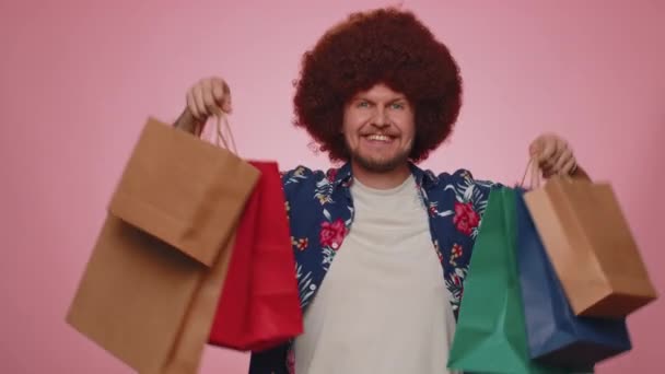 Happy Tourist Man Lush Hair Showing Shopping Bags Advertising Discounts — ストック動画