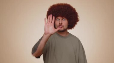 No stop. Serious adult man say No, hold palm folded crossed hands in stop danger gesture, warning of finish, prohibited access, declining communication, body language. Young guy on beige background
