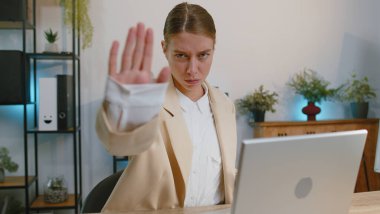 Stop gesture. Angry businesswoman girl working at office workplace . Woman say No hold palm folded crossed hands, warning of finish, prohibited access, declining communication, body language, danger