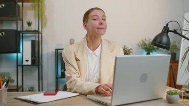 Businesswoman working with documents at office desk, taking a break, playing smartphone game. Manager freelancer woman winner celebrate mobile phone online win victory success receive read good news