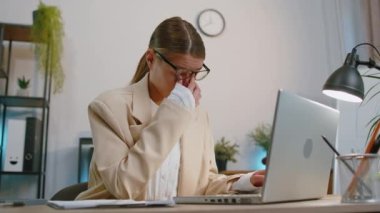 Businesswoman in suit closing laptop pc computer after finishing work at home office desk. Smiling manager freelancer woman busy working online, remote job. E-learning, browsing internet on notebook