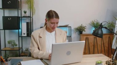 Dislike. Upset businesswoman working on laptop computer at home office thumbs down sign gesture, expressing discontent, disapproval, dissatisfied bad work. Displeased serious female freelancer girl