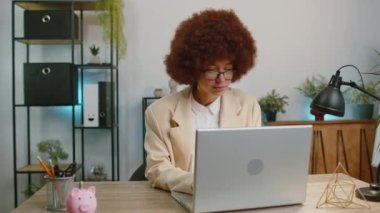 Like. Happy business woman working on laptop looking approvingly at camera showing thumbs up, like sign positive something good, positive feedback at office workplace desk. Freelancer adult girl