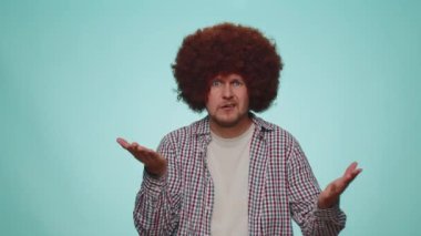 You are crazy, out of mind. Upset displeased bearded man pointing at camera and showing stupid gesture, blaming some idiot for insane plan. Young adult guy boy isolated alone on blue studio background