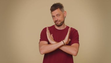 I am dont want it, not me. Confused upset young man pointing fingers hisself ask say who why me no thanks i do not need it, rejection, refusal, stop sign. Adult stylish guy on beige background
