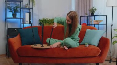 Portrait of caucasian student girl child kid finishing assembling furniture at home living room. Successful table collect, repair, fixing. Young woman after moving into new apartment. Mortgage concept
