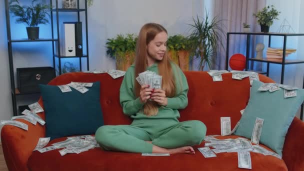 成功的富商女人 数钱的时候 带着很高的利润 彩票游戏赢了 满足了财富收入的薪水 在家里的沙发上躺着满满的钞票 — 图库视频影像