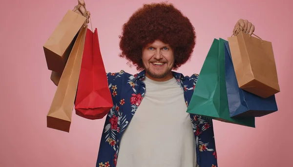 Happy Tourist Man Lush Hair Showing Shopping Bags Advertising Discounts — 图库照片