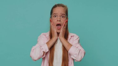 Stressed depressed girl terrified about danger problems, suffering phobia, anxiety disorder, expresses fear, waving no, insecure, stress, panic. Child kid isolated on blue studio background indoors