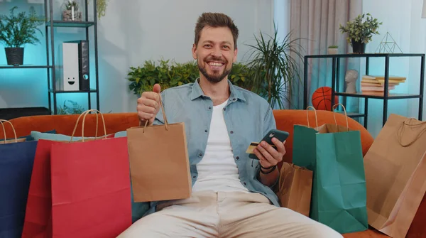 Happy Shopaholic Consumer Man Sitting Shopping Bags Modern Home Apartment — Stockfoto