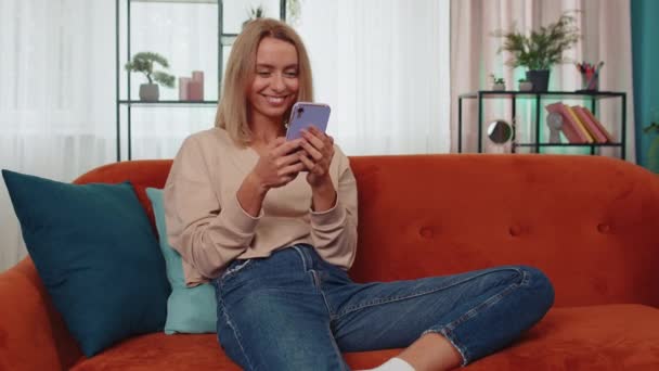 Portrait Adult Girl Sitting Sofa Uses Mobile Phone Smile Modern — Stock videók