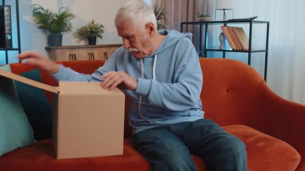 Happy Senior Grandfather Unpacking Delivery Parcel Sitting Home Smiling Satisfied — 图库视频影像