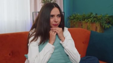 Upset disappointed caucasian young woman wipes tears and cries from despair, being sad because of unfair situation, unrequited love. Problem, break up, depressed feeling bad annoyed, burnout at home