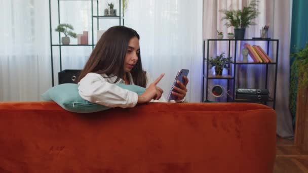 Portrait Adult Girl Sitting Sofa Uses Mobile Phone Smile Modern — Vídeo de Stock