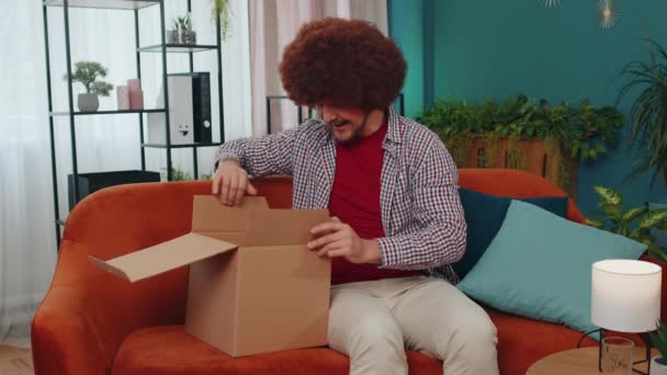 Happy Surprised Winner Adult Man Unpacking Delivery Parcel Home Smiling — Stockvideo