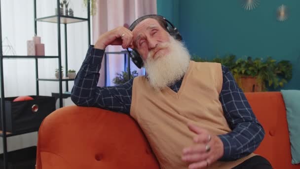 Happy Overjoyed Elderly Man Wireless Headphones Dancing Relaxing Couch Home — Stock Video