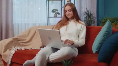 Oh my God Wow. Young woman use laptop computer, receive good news message, shocked by sudden victory, celebrate win, purchases online shopping at home. Modern technologies. Amazed caucasian girl