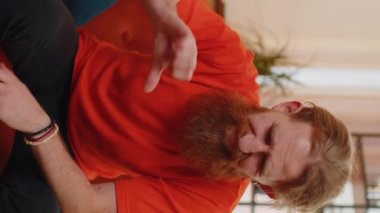 Dislike. Upset man showing thumbs down sign gesture, expressing discontent, disapproval, dissatisfied bad work at modern home apartment indoors. Displeased young guy in living room sitting on sofa